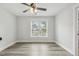 A bedroom featuring a ceiling fan, a large window, and hardwood floors at 212 Lynch Ave, Lillington, NC 27546
