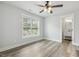 A bedroom with a view of the back yard, neutral walls, and durable gray flooring at 212 Lynch Ave, Lillington, NC 27546