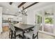 Dining area with stylish chandelier and access to a covered patio, adjacent to the kitchen and living area at 212 Lynch Ave, Lillington, NC 27546