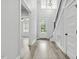 Bright foyer boasts hardwood floors, a staircase with black metal spindles, and natural light streaming through the front door at 212 Lynch Ave, Lillington, NC 27546
