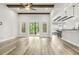 Open living area with wood beams, recessed lighting, and sliding glass doors leading to an outdoor deck at 212 Lynch Ave, Lillington, NC 27546