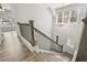 A staircase with wood stairs, a chandelier, and black iron balusters at 212 Lynch Ave, Lillington, NC 27546