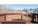 Wood deck with railing overlooks the tree filled backyard at 2203 Eider Ct # A, Graham, NC 27253