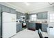 Functional kitchen featuring grey cabinetry, modern appliances, and lots of counter space at 2203 Eider Ct # A, Graham, NC 27253
