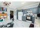 Bright eat-in kitchen featuring stainless steel appliances, grey cabinets and modern white marble tile flooring at 2203 Eider Ct # A, Graham, NC 27253