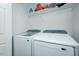 Bright Laundry room with white washer and dryer and a shelf for detergent at 2203 Eider Ct # A, Graham, NC 27253