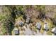 Aerial view of homes surrounded by mature trees and landscaping in a neighborhood with a community pool at 224 Hartshorn Ct, Holly Springs, NC 27540