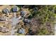 Overhead view of a quiet suburban neighborhood with homes featuring mature trees and lush landscapes at 224 Hartshorn Ct, Holly Springs, NC 27540