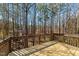 Wood deck overlooking a densely wooded backyard, offering privacy and scenic views at 224 Hartshorn Ct, Holly Springs, NC 27540