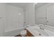 Bright bathroom with a shower-tub combo and a single sink vanity with a large mirror at 224 Hartshorn Ct, Holly Springs, NC 27540