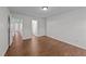 Open bedroom has hardwood floors and two entryways at 224 Hartshorn Ct, Holly Springs, NC 27540