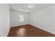 Cozy bedroom with wood-look floors and a bright window at 224 Hartshorn Ct, Holly Springs, NC 27540