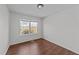 This bedroom features a window providing lots of natural light and attractive flooring at 224 Hartshorn Ct, Holly Springs, NC 27540