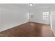 Neutral bedroom with hardwood floors and double windows for natural light at 224 Hartshorn Ct, Holly Springs, NC 27540