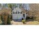 Charming two-story home with a two-car garage, a welcoming front porch, and dark shutters at 224 Hartshorn Ct, Holly Springs, NC 27540