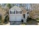 Charming two-story home with a two-car garage, a welcoming front porch, and dark shutters at 224 Hartshorn Ct, Holly Springs, NC 27540