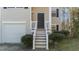 Inviting home front porch featuring well-kept landscaping and classic design elements at 224 Hartshorn Ct, Holly Springs, NC 27540
