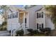Inviting home front porch featuring well-kept landscaping and classic design elements at 224 Hartshorn Ct, Holly Springs, NC 27540