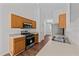 Modern kitchen featuring stainless steel appliances, wood cabinets, and dark laminate flooring at 224 Hartshorn Ct, Holly Springs, NC 27540