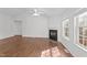 Living room features a fireplace, ceiling fan, and large windows for natural light at 224 Hartshorn Ct, Holly Springs, NC 27540
