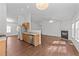 Open-concept living room boasts wood floors, fireplace, and stainless steel appliances at 224 Hartshorn Ct, Holly Springs, NC 27540