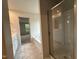 Bathroom with marble tile, soaking tub, glass shower and double vanity at 260 Johnson Ridge Way, Four Oaks, NC 27524