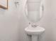 Stylish half-bathroom with a pedestal sink, oval mirror, and modern fixtures at 260 Johnson Ridge Way, Four Oaks, NC 27524