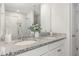 Bright bathroom with a double vanity, granite countertop, and tiled walk-in shower at 260 Johnson Ridge Way, Four Oaks, NC 27524