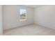 A clean, cozy bedroom with neutral carpet and a bright window view at 260 Johnson Ridge Way, Four Oaks, NC 27524