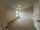 Neutral bedroom featuring plush carpeting, natural light and spacious design at 260 Johnson Ridge Way, Four Oaks, NC 27524