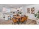 Cozy dining area with a wood table, six chairs, and an open view of the kitchen at 260 Johnson Ridge Way, Four Oaks, NC 27524