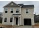This two-story home boasts vinyl siding, an attached garage, and a classic architectural design at 260 Johnson Ridge Way, Four Oaks, NC 27524
