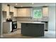 Modern kitchen with granite countertops, stainless steel appliances, and kitchen island at 260 Johnson Ridge Way, Four Oaks, NC 27524