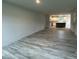 Open-concept living room features durable floors and seamless flow into the modern kitchen at 260 Johnson Ridge Way, Four Oaks, NC 27524
