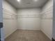 Spacious walk-in closet with ample shelving and carpeting at 260 Johnson Ridge Way, Four Oaks, NC 27524