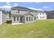 Spacious backyard of home with a patio, a manicured lawn, and lush greenery at 267 N Maple Walk Dr # 217, Garner, NC 27529