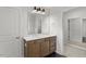Bathroom featuring modern lighting, vanity, fixtures, and walk-in closet views at 267 N Maple Walk Dr # 217, Garner, NC 27529