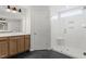Modern bathroom featuring marble floors, a glass shower, and granite countertops at 267 N Maple Walk Dr # 217, Garner, NC 27529