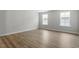 Bright bedroom with wood floors and natural light streaming through windows at 267 N Maple Walk Dr # 217, Garner, NC 27529