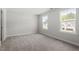 Serene bedroom with plush carpet and large windows overlooking the landscape at 267 N Maple Walk Dr # 217, Garner, NC 27529