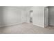 Spacious carpeted bedroom with multiple doorways, offering comfort and accessibility at 267 N Maple Walk Dr # 217, Garner, NC 27529