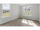 Bedroom with luxury vinyl plank flooring, large windows, and natural light at 267 N Maple Walk Dr # 217, Garner, NC 27529
