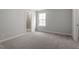 Calm bedroom, with carpet, featuring natural light, adjoining bathroom and closet at 267 N Maple Walk Dr # 217, Garner, NC 27529