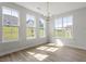 A dining room features a chandelier and many windows providing natural light at 267 N Maple Walk Dr # 217, Garner, NC 27529