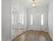 Open foyer with wood flooring, stylish lighting, and glass panel French doors at 267 N Maple Walk Dr # 217, Garner, NC 27529