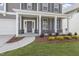 Close-up of the covered porch with stone accents, a welcoming door, and landscaping adding to the curb appeal at 267 N Maple Walk Dr # 217, Garner, NC 27529