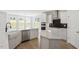 Bright kitchen featuring white cabinets, stainless steel appliances, large sink, and light colored flooring at 267 N Maple Walk Dr # 217, Garner, NC 27529