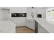 A bright kitchen displays white cabinetry, stainless steel appliances, and black backsplash at 267 N Maple Walk Dr # 217, Garner, NC 27529