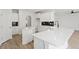 Bright kitchen showcases a large island with a sink, white cabinets, and modern finishes at 267 N Maple Walk Dr # 217, Garner, NC 27529