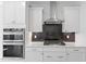 The kitchen shows white cabinets, a stainless steel oven set, and stainless steel exhaust hood at 267 N Maple Walk Dr # 217, Garner, NC 27529